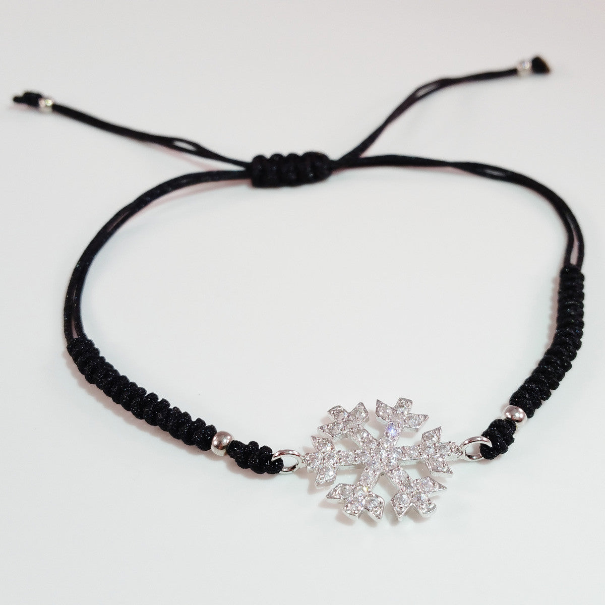 925 STERLING SILVER CZ CRYSTAL SNOWFLAKE ON THREADED BRAIDED BRACELET.