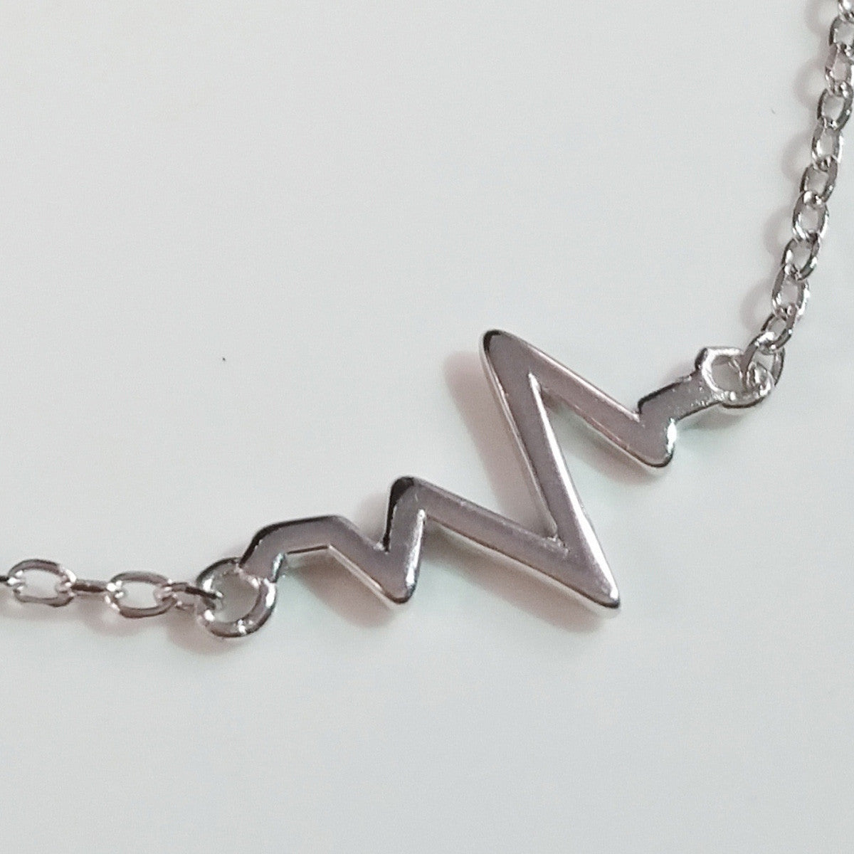925 STERLING SILVER BRACELET WITH EKG HEARTBEAT CHARM.