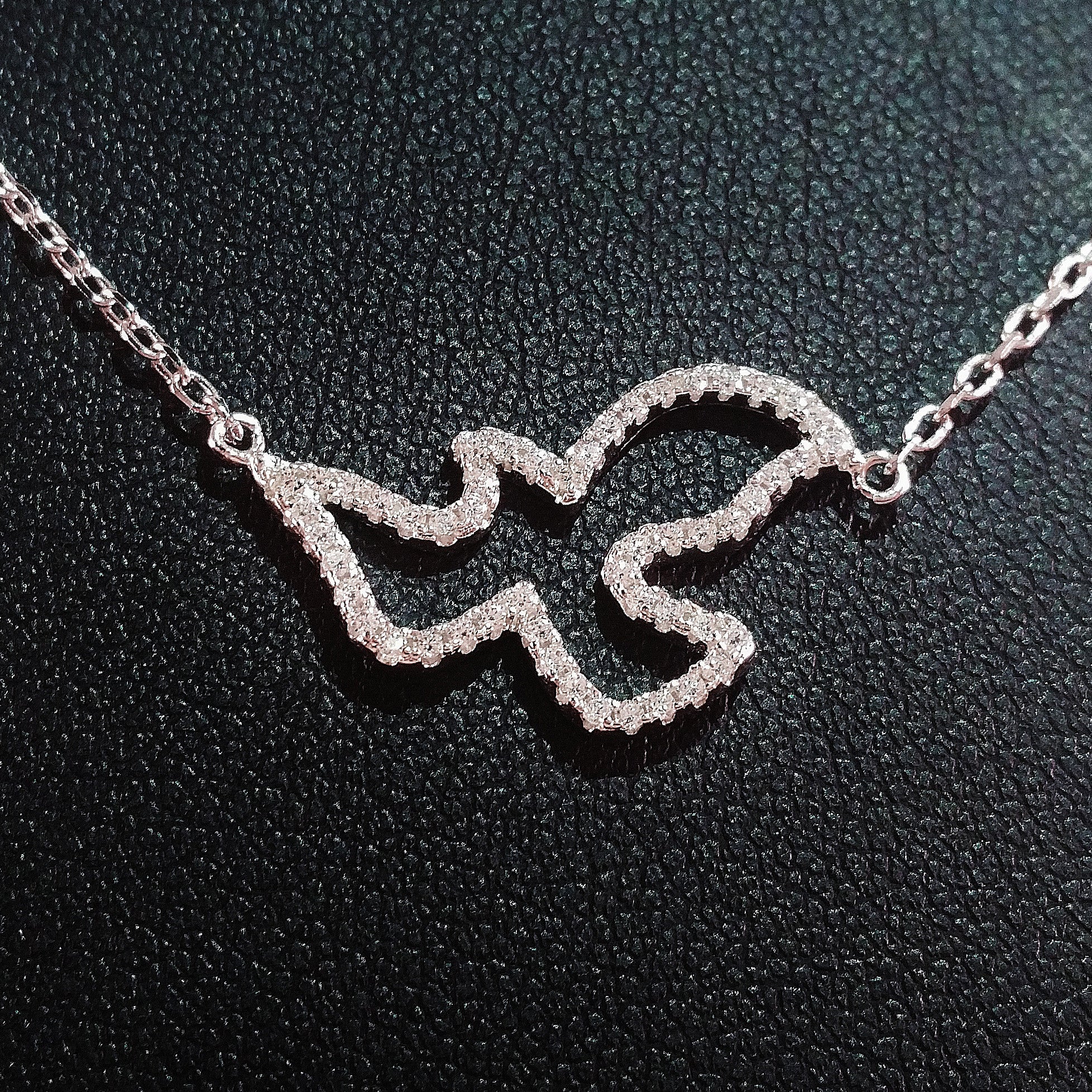 925 STERLING SILVER NECKLACE WITH DOVE PENDANT SET IN SPARKLING CRYSTALS.