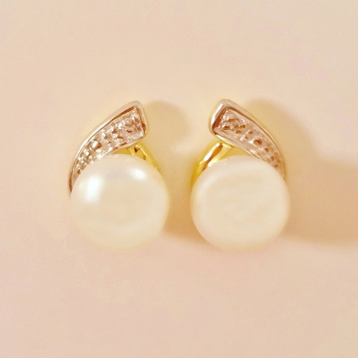 9K SOLID GOLD 7.00MM FRESHWATER PEARL AND DIAMOND EARRINGS.