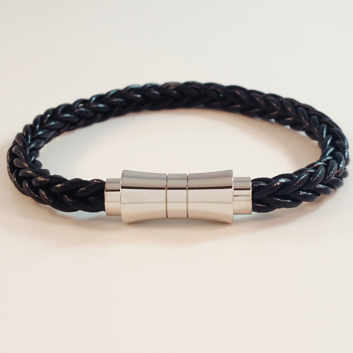 MEN'S BLACK BRAIDED COW HIDE LEATHER BRACELET WITH STAINLESS STEEL CLASP.