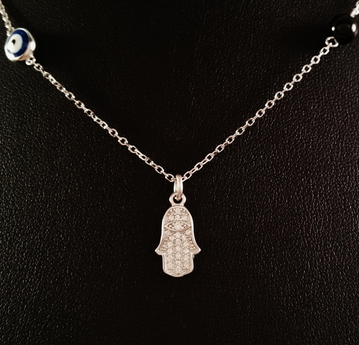 925 STERLING SILVER NECKLACE WITH TURKISH EVIL EYE CHARM AND HAMSA HAND PENDANT SET IN SPARKLING CRYSTALS.