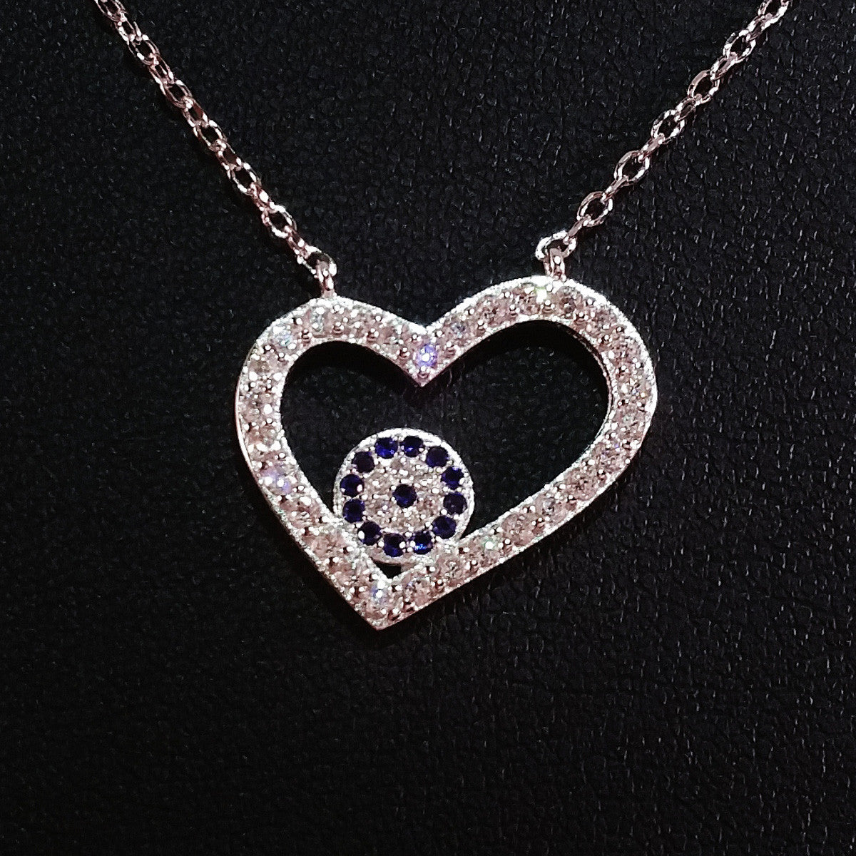 925 STERLING SILVER NECKLACE WITH OPEN HEART EVIL EYE PENDANT SET IN SPARKLING CRYSTALS.