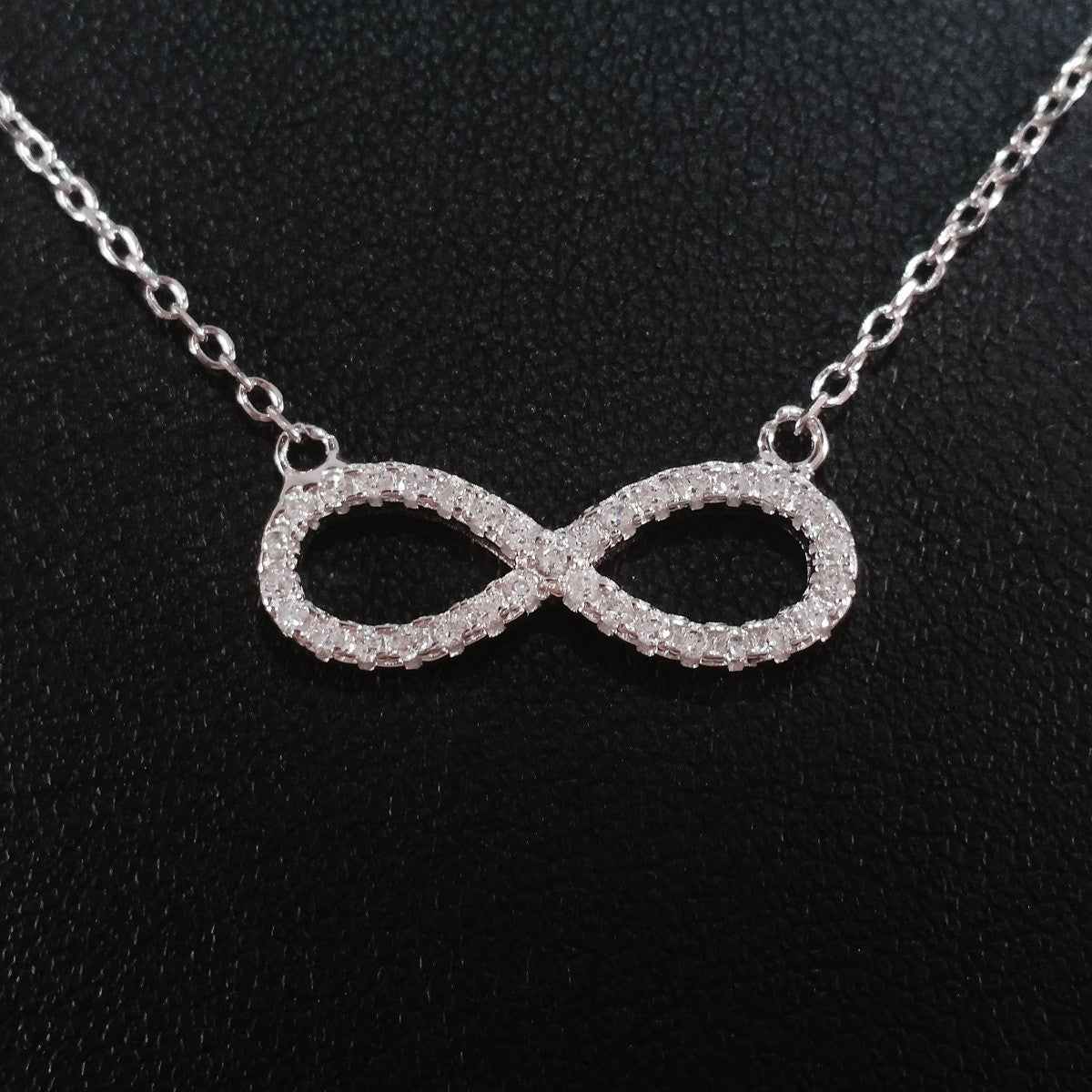 925 STERLING SILVER NECKLACE WITH ETERNITY PENDANT SET IN SPARKLING CRYSTALS.