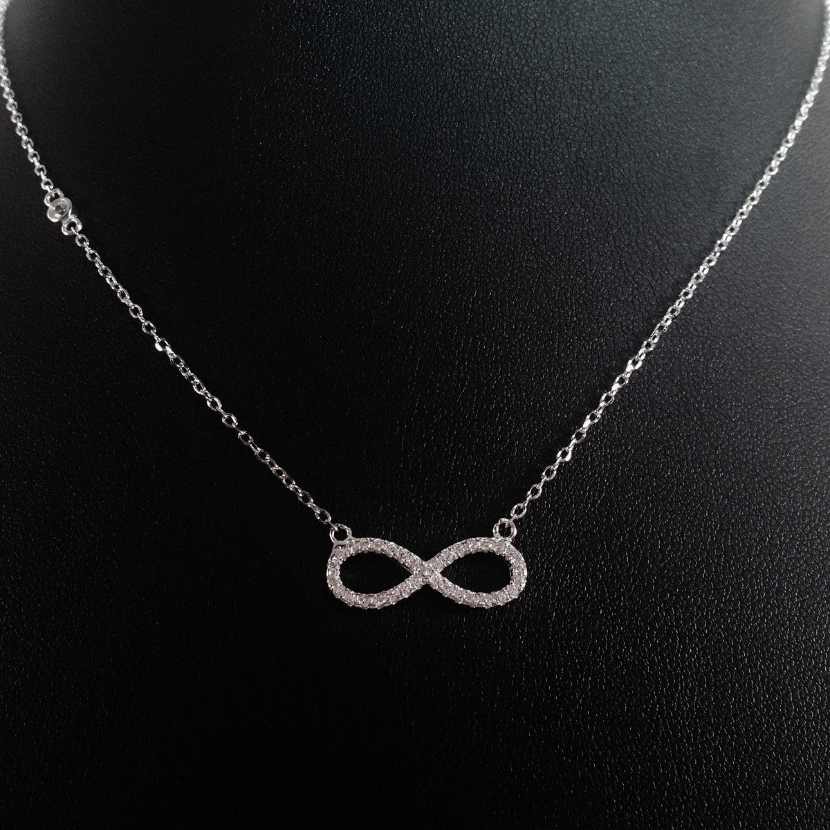 925 STERLING SILVER NECKLACE WITH ETERNITY PENDANT SET IN SPARKLING CRYSTALS.