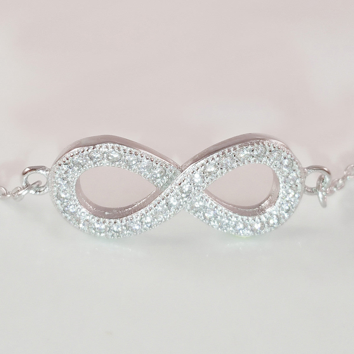 925 STERLING SILVER BRACELET WITH ETERNITY CHARM PAVED WITH SPARKLING CZ CRYSTALS.