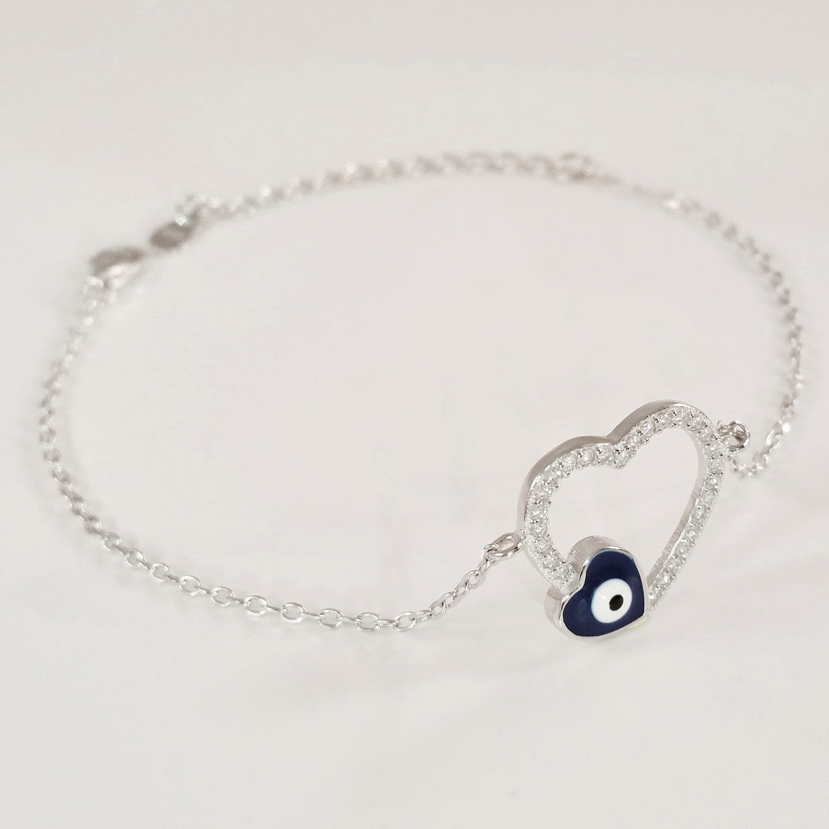 925 STERLING SILVER BRACELET WITH OPEN HEART EVIL EYE CHARM PAVED WITH SPARKLING CZ CRYSTALS.