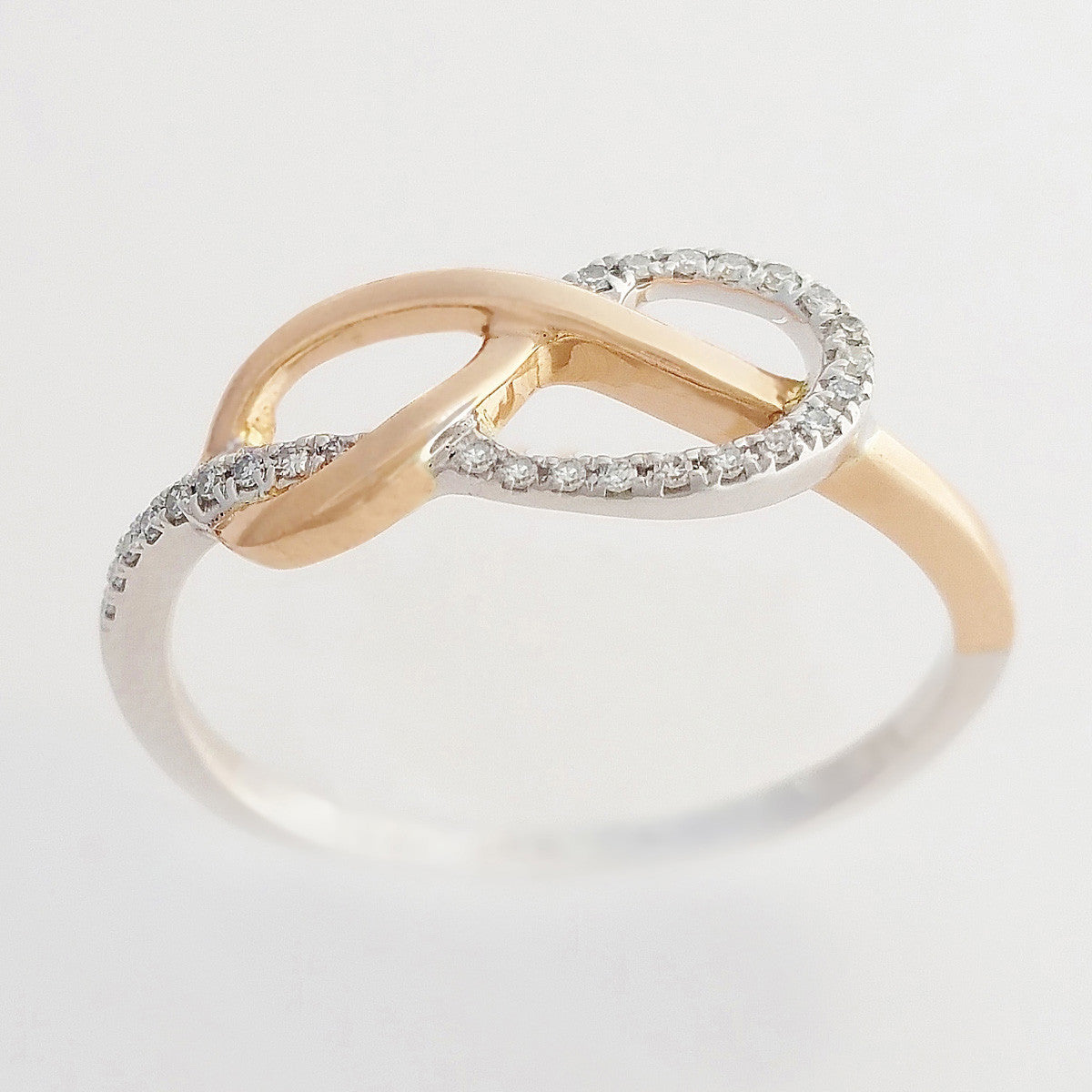 9K SOLID ROSE GOLD & WHITE GOLD INFINITY RING WITH 26 DIAMONDS.