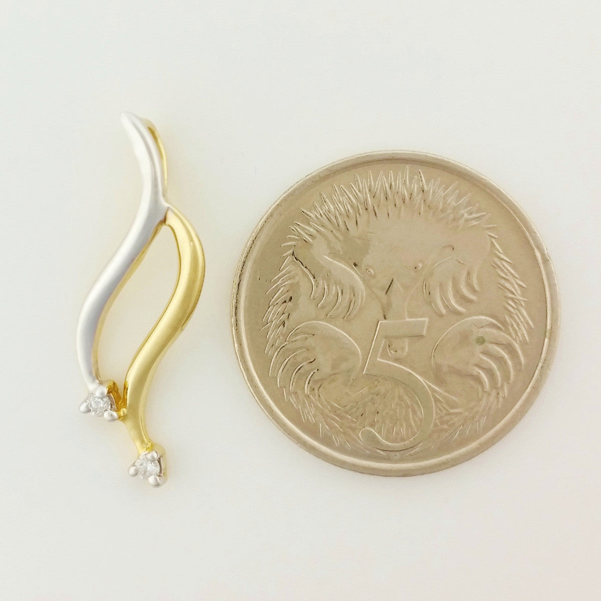 9K SOLID YELLOW AND WHITE GOLD PENDANT WITH TWO DIAMONDS.