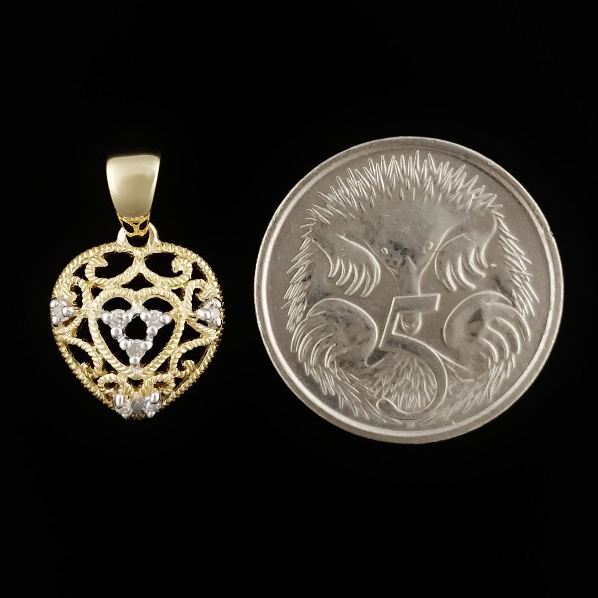 9K SOLID GOLD FILIGREE HEART PENDANT WITH 7 DIAMONDS.