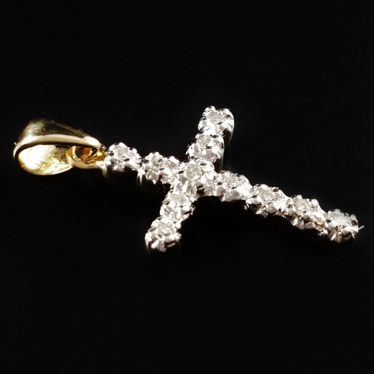 9K SOLID GOLD CROSS PENDANT WITH 11 DIAMONDS.