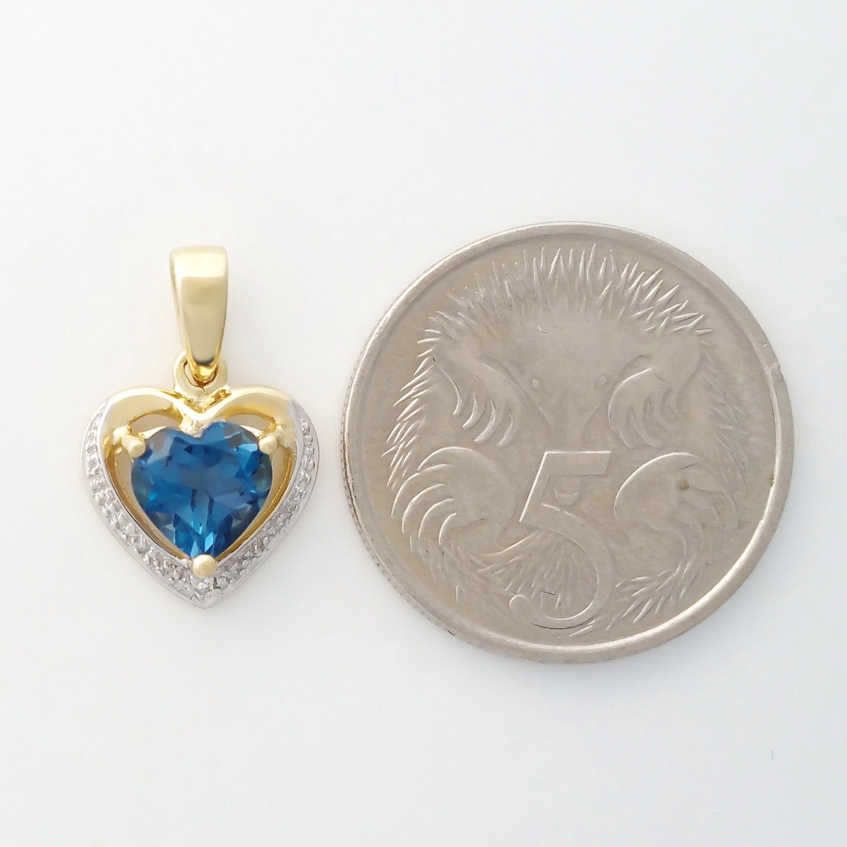 9K SOLID GOLD 1.20CT LONDON BLUE TOPAZ AND DIAMOND PENDANT.