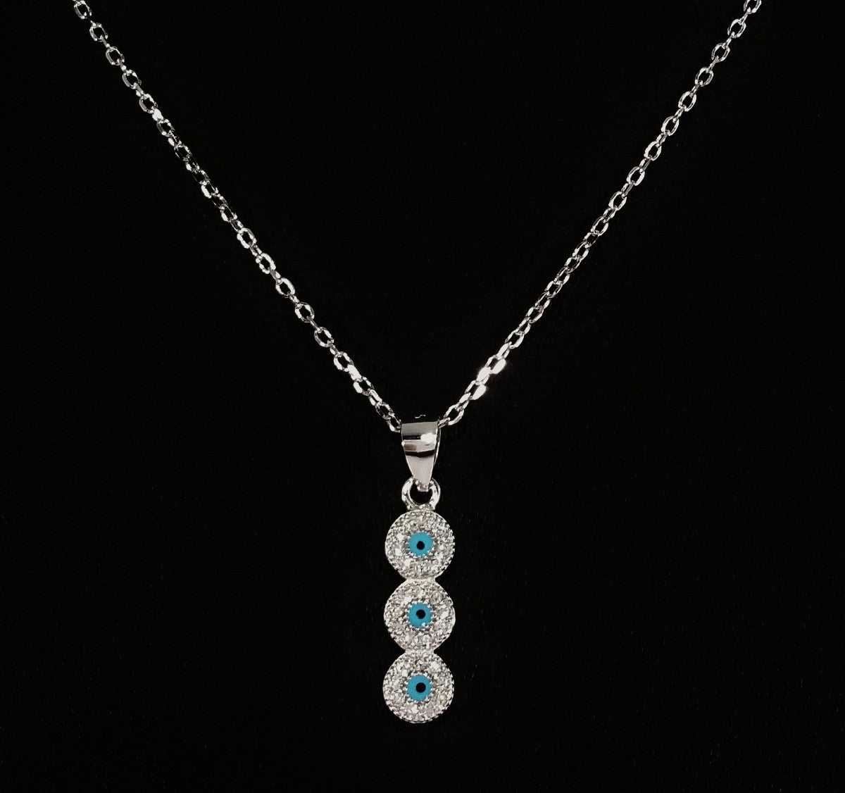 925 STERLING SILVER NECKLACE WITH TRILOGY EVIL EYE PENDANT SET IN SPARKLING CRYSTALS.
