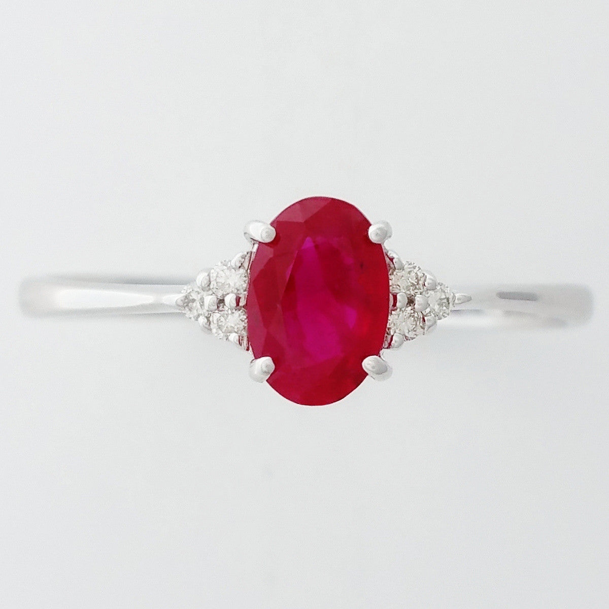 9K SOLID WHITE GOLD 0.60CT NATURAL OVAL RUBY RING WITH 6 DIAMONDS.