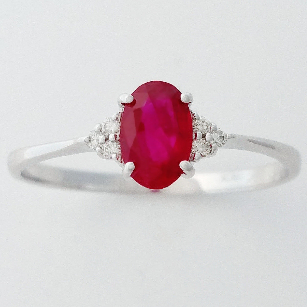 9K SOLID WHITE GOLD 0.60CT NATURAL OVAL RUBY RING WITH 6 DIAMONDS.