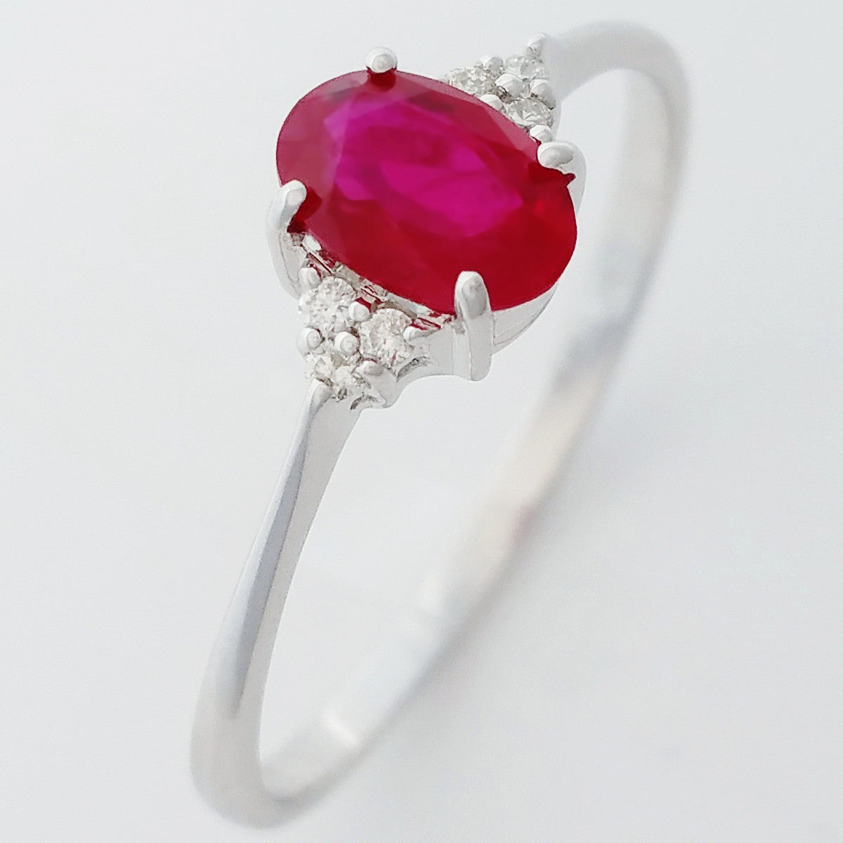 9K SOLID WHITE GOLD 0.60CT NATURAL OVAL RUBY RING WITH 6 DIAMONDS.