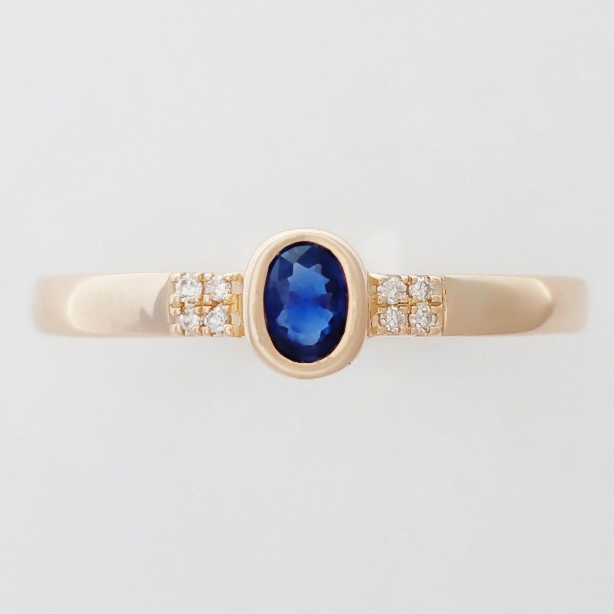 9K SOLID ROSE GOLD 0.20CT NATURAL OVAL BLUE SAPPHIRE RING WITH 8 DIAMONDS.