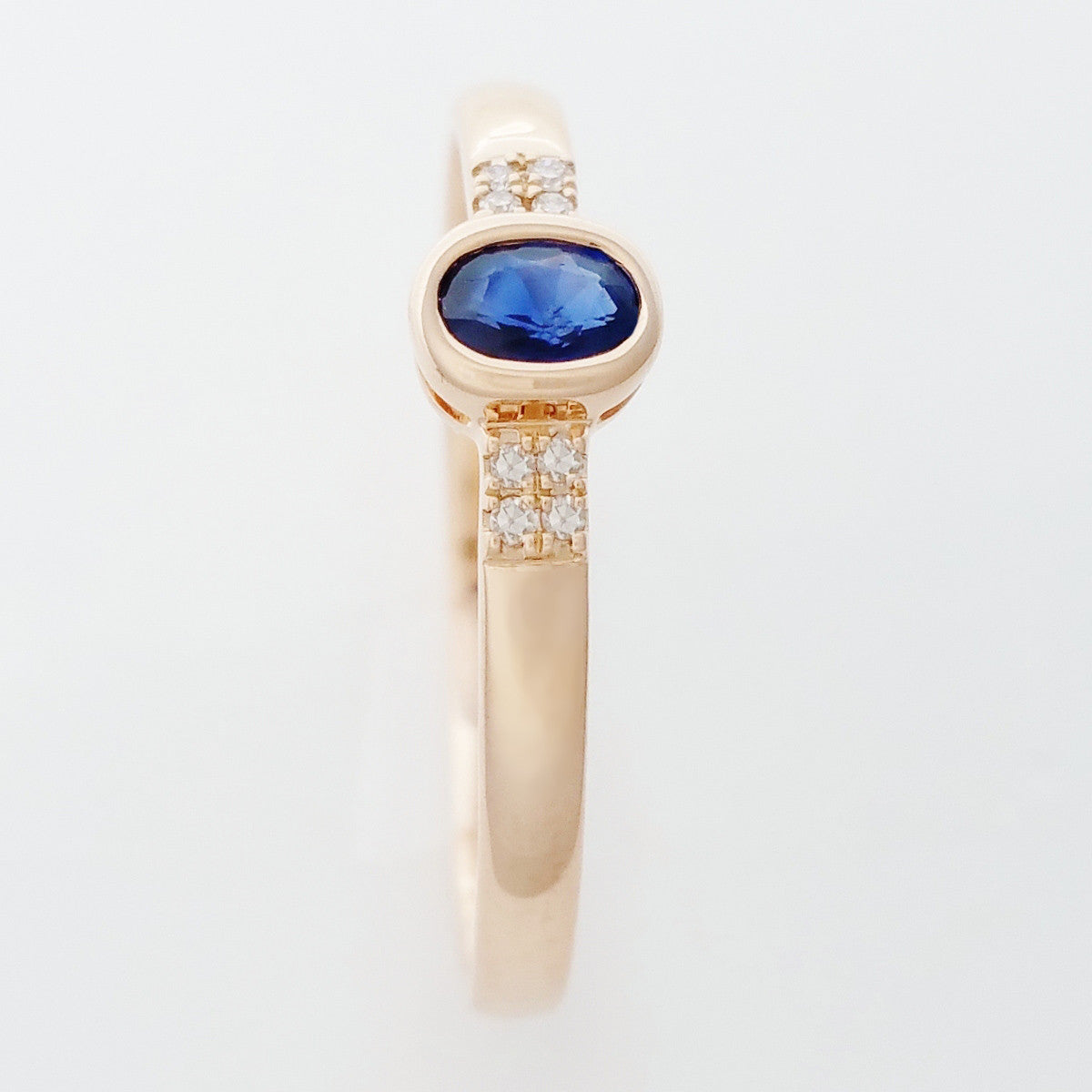 9K SOLID ROSE GOLD 0.20CT NATURAL OVAL BLUE SAPPHIRE RING WITH 8 DIAMONDS.