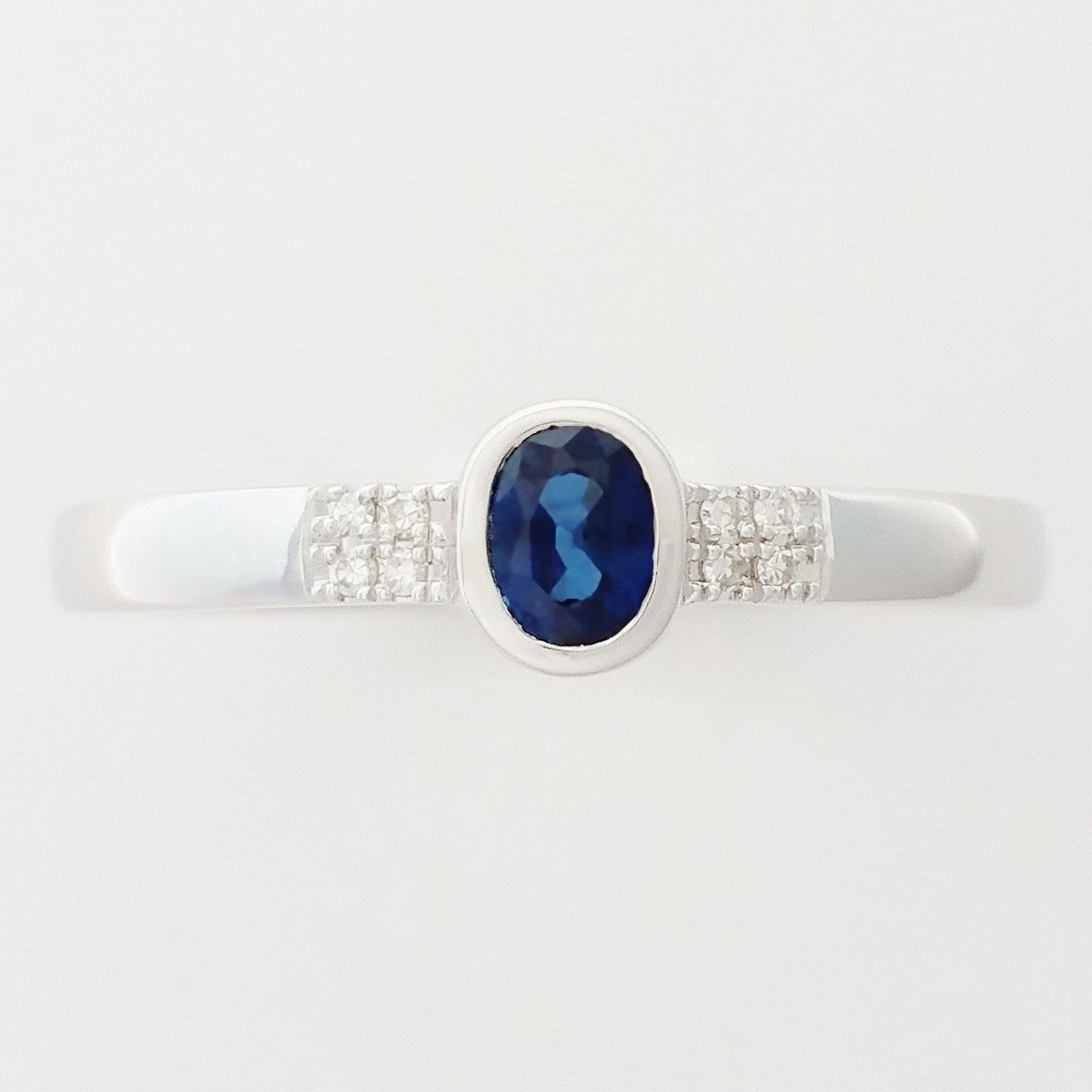 9K SOLID WHITE GOLD 0.25CT NATURAL OVAL BLUE SAPPHIRE RING WITH 8 DIAMONDS.