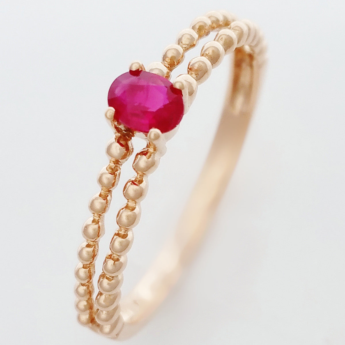 9K SOLID ROSE GOLD 0.25CT NATURAL RUBY RING WITH BEADED SHOULDERS.