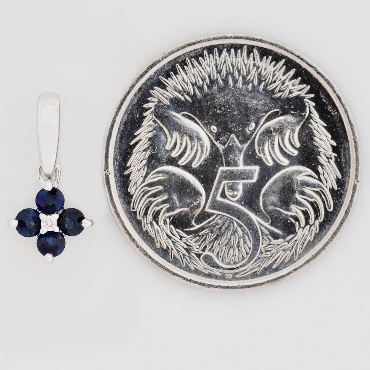 9K SOLID WHITE GOLD 0.20CT SAPPHIRE CLUSTER PENDANT WITH CENTRE DIAMOND.
