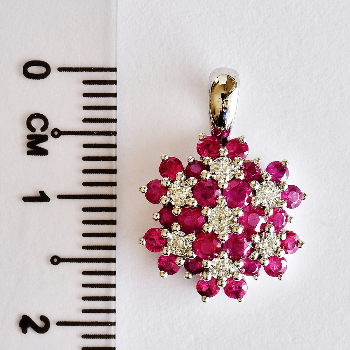 9K SOLID WHITE GOLD 0.85CT NATURAL RUBY CLUSTER PENDANT WITH SEVEN DIAMONDS.