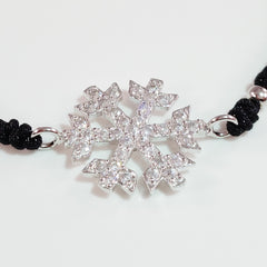 925 STERLING SILVER CZ CRYSTAL SNOWFLAKE ON THREADED BRAIDED BRACELET.