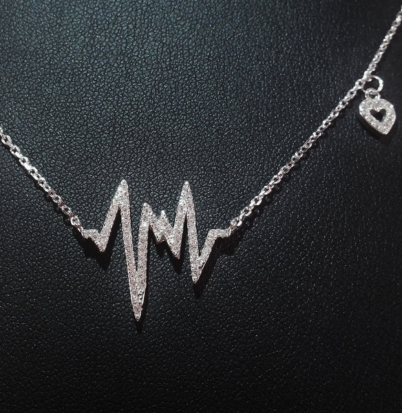 925 STERLING SILVER NECKLACE WITH EKG HEARTBEAT PENDANT SET IN SPARKLING CRYSTALS.