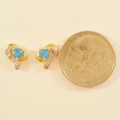 9K SOLID GOLD 0.45CT SWISS BLUE TOPAZ AND DIAMOND STUD EARRINGS.