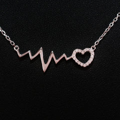 925 STERLING SILVER NECKLACE WITH EKG HEARTBEAT AND LOVE-HEART PENDANT SET IN SPARKLING CRYSTALS.