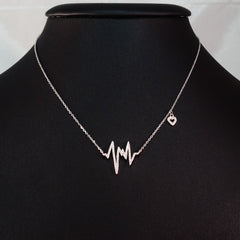 925 STERLING SILVER NECKLACE WITH EKG HEARTBEAT PENDANT SET IN SPARKLING CRYSTALS.
