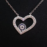 925 STERLING SILVER NECKLACE WITH OPEN HEART EVIL EYE PENDANT SET IN SPARKLING CRYSTALS.