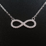 925 STERLING SILVER NECKLACE WITH ETERNITY PENDANT SET IN SPARKLING CRYSTALS.