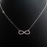 925 STERLING SILVER NECKLACE WITH ETERNITY PENDANT SET IN SPARKLING CRYSTALS.