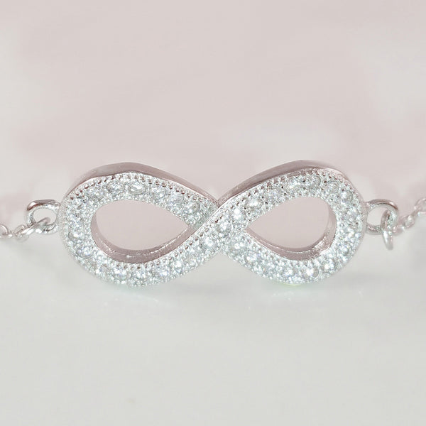 925 STERLING SILVER BRACELET WITH ETERNITY CHARM PAVED WITH  SPARKLING CZ CRYSTALS.