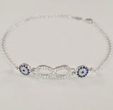 925 STERLING SILVER BRACELET WITH ETERNITY SYMBOL AND DOUBLE EVIL EYE CHARM PAVED WITH  SPARKLING CZ CRYSTALS.