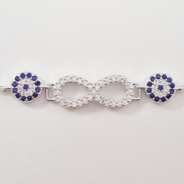 925 STERLING SILVER BRACELET WITH ETERNITY SYMBOL AND DOUBLE EVIL EYE CHARM PAVED WITH  SPARKLING CZ CRYSTALS.