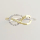 9K SOLID WHITE GOLD & YELLOW GOLD INFINITY RING WITH 26 DIAMONDS.