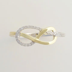 9K SOLID WHITE GOLD & YELLOW GOLD INFINITY RING WITH 26 DIAMONDS.