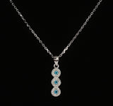 925 STERLING SILVER NECKLACE WITH TRILOGY EVIL EYE PENDANT SET IN SPARKLING CRYSTALS.