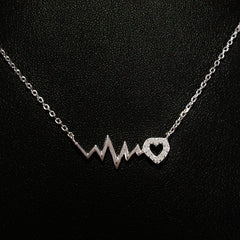 925 STERLING SILVER NECKLACE WITH EKG HEARTBEAT AND CRYSTAL LOVE-HEART PENDANT.