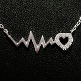 925 STERLING SILVER NECKLACE WITH EKG HEARTBEAT AND CRYSTAL LOVE-HEART PENDANT.