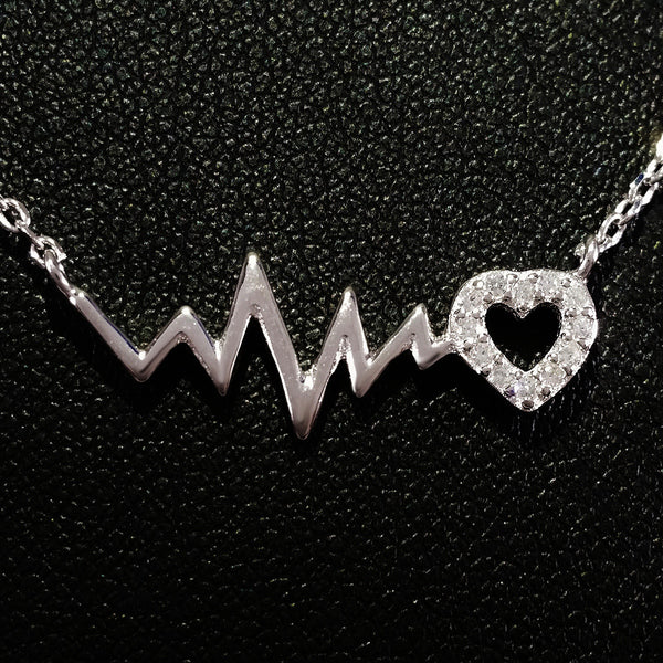 925 STERLING SILVER NECKLACE WITH EKG HEARTBEAT AND CRYSTAL LOVE-HEART PENDANT.
